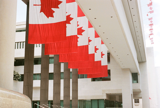 canadian flags in front of a building used for Canadian Hazardous Products Regulations updates blog